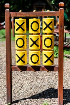 Tic-tac-toe game on the playground in sunny weather