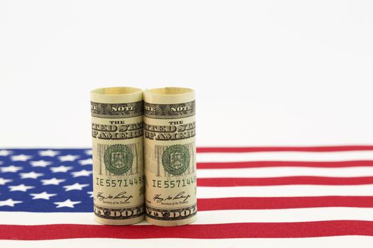 Still life of pair of dollars on American flag.  Horizontal photo with copy space.  