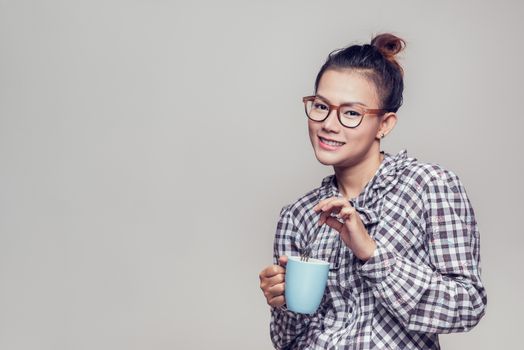 Asian woman smiling with a blue cup, Happy mood
