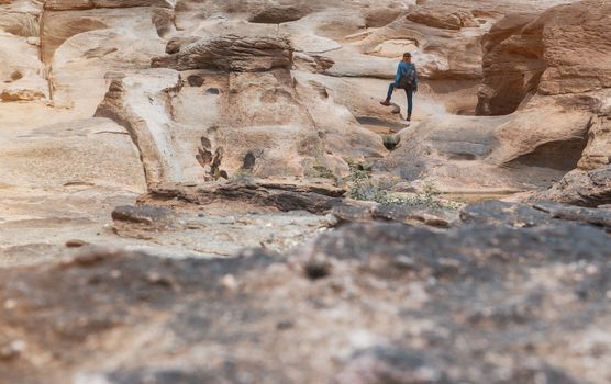  Asia woman taking a photo at Sampanbok natural stone park the grand-canyon of Ubonratchathani Thailand