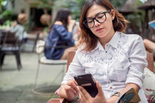 Asian woman taking notes on the phone with the intention,Focus face