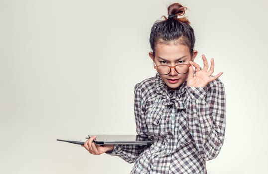 Asian woman standing with suspicion.