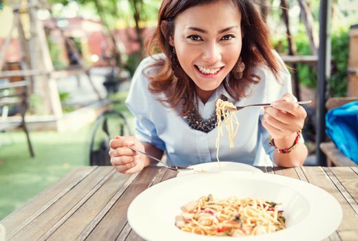 Asian women eating delicious,Focus on face