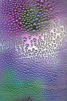 Abstract background. Drops of water on the crooked glass, shallow dof