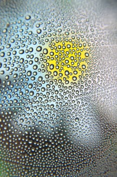 Abstract background. Drops of water on the crooked glass, shallow dof