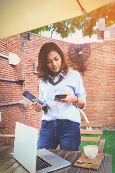 Asian women are using their mobile phones. Happy mood