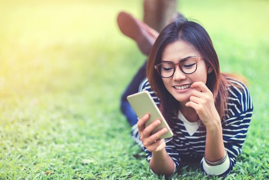 Asian women are using their mobile phone Happy mood,focus on face 
