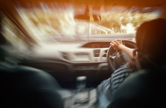 Photo Asian woman driving a car safely,blurred image