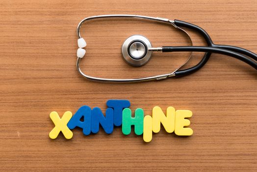 xanthine colorful word with stethoscope on wooden background