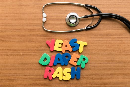 yeast diaper rash colorful word with stethoscope on wooden background