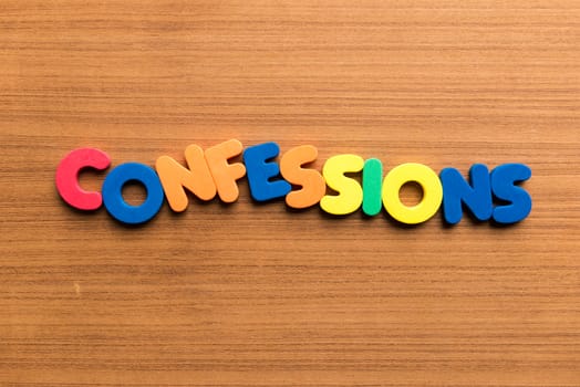 confessions colorful word on the wooden background