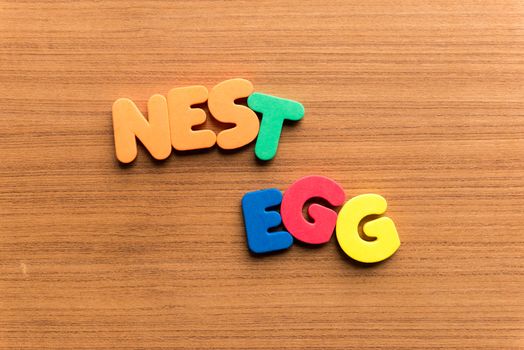 nest egg colorful word on the wooden background