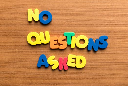 no questions asked colorful word on the wooden background