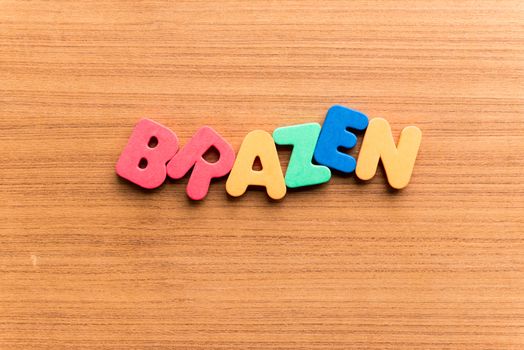 brazen colorful word on the wooden background