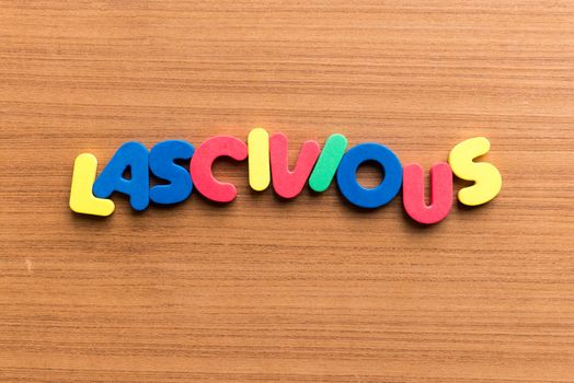 lascivious colorful word on the wooden background