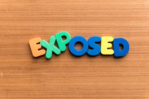 exposed colorful word on the wooden background