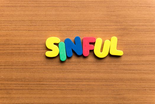 sinful colorful word on the wooden background