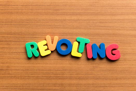 revolting colorful word on the wooden background