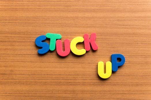 stuck up colorful word on the wooden background
