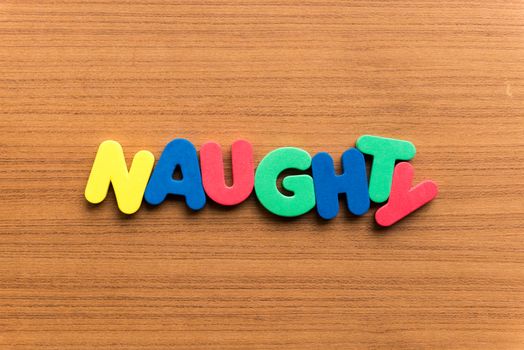 naughty colorful word on the wooden background