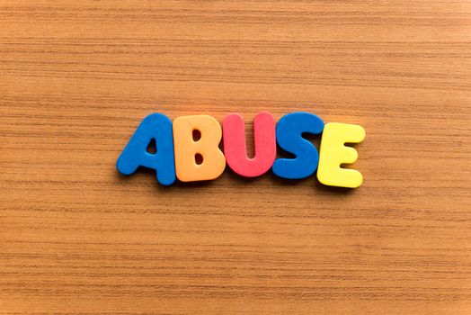 abuse colorful word on the wooden background