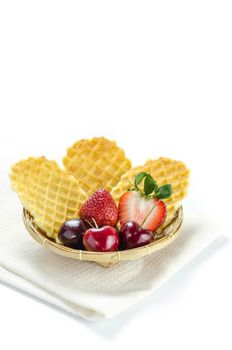 fresh berries fruit and waffles in bamboo basket
