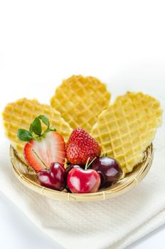 fresh berries fruit and waffles in bamboo basket