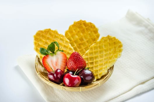 fresh berries fruit and waffles in bamboo basket