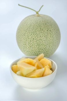 freshly cut cantaloupe melon on white background