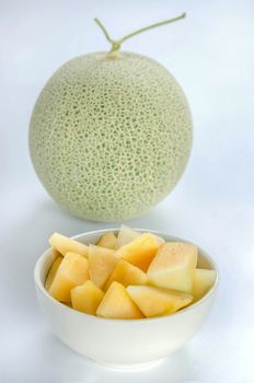 freshly cut cantaloupe melon on white background