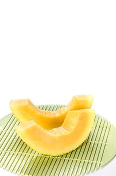 freshly cut cantaloupe melon on white background