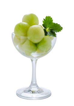 Fresh green cantaloupe melon in glass on a white background