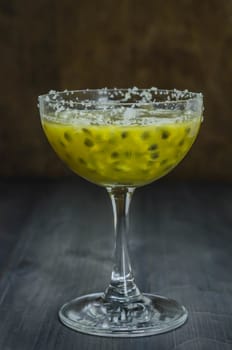 Fresh passion fruit juice in glass over wooden background , still life