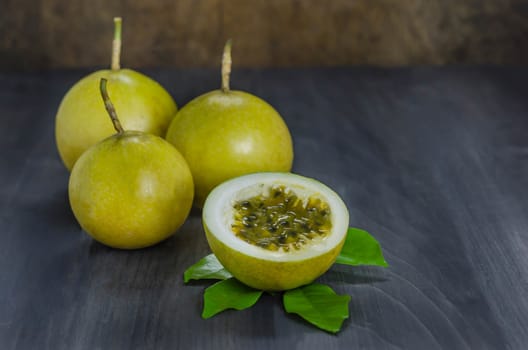 Fresh passion fruit and half over wooden background , still life