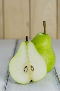 One and a half green pears over white background