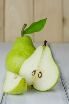 One and a half green pears over white background