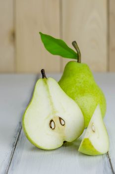One and a half green pears over white background