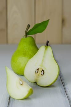 One and a half green pears over white background