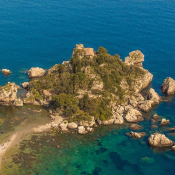 Italy, Taormina - Sicily. Aerial view of Isola Bella's island and beach on blue mediterranean water.