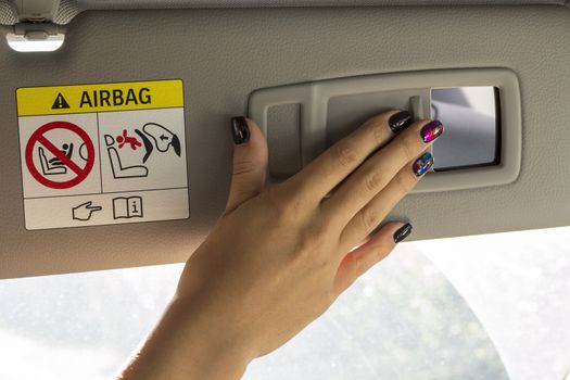 close-up of a girl's hand with a beautiful manicure in Salon car