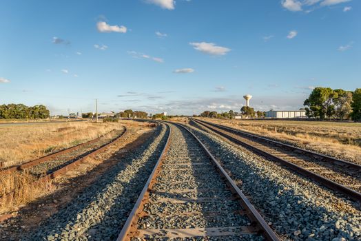 Two curved railroad tracks and one straight.  One of the curved tracks has not been used for a long time, judging by the rust on it.