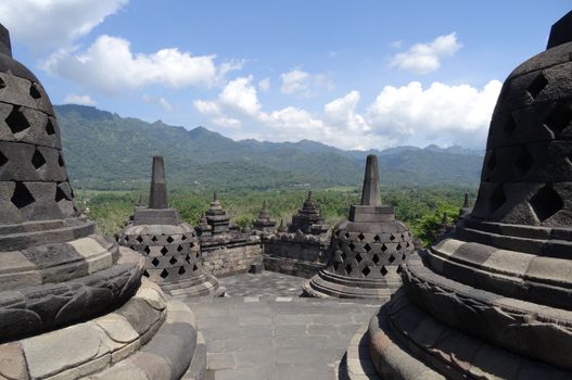 Borobudur Temple Indonesia clear blue sky with hills in the distance