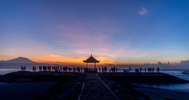 People relaxing watching a sunrise in Sanur Bali