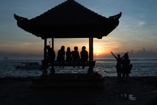 People relaxing watching a sunrise in Sanur Bali