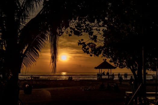 People relaxing watching a sunrise in Sanur Bali