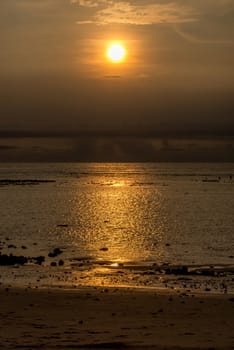 Sunset in Bali with fishermen in the distance