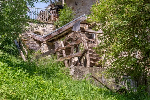 old water wheel on the side of a building