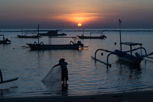Sunrise in Sanur Bali, Indonesia, with traditional boats