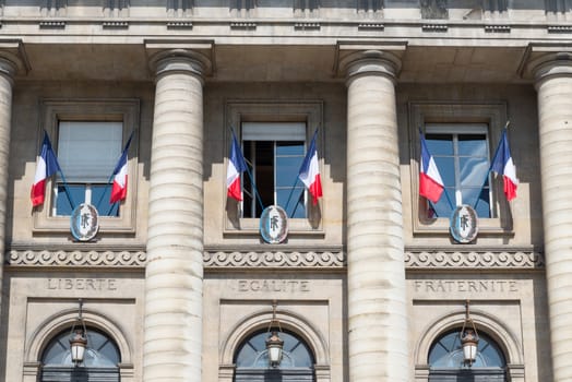 French flags outside windows above the words liberty, equality and fraternity