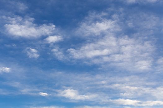 The beautiful blue sky with white clouds in the light of a rising sun